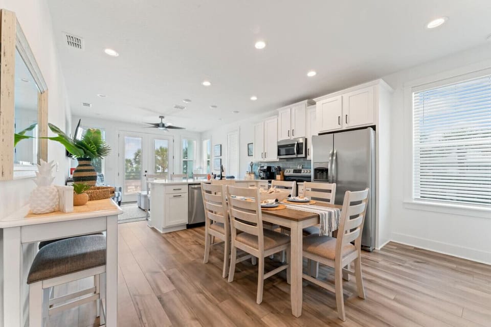 Fully stocked open kitchen with all-new appliances, cookware, and a dual drip/K-Cup coffee maker—plus seating at the bar and dining table for easy meals and conversation.