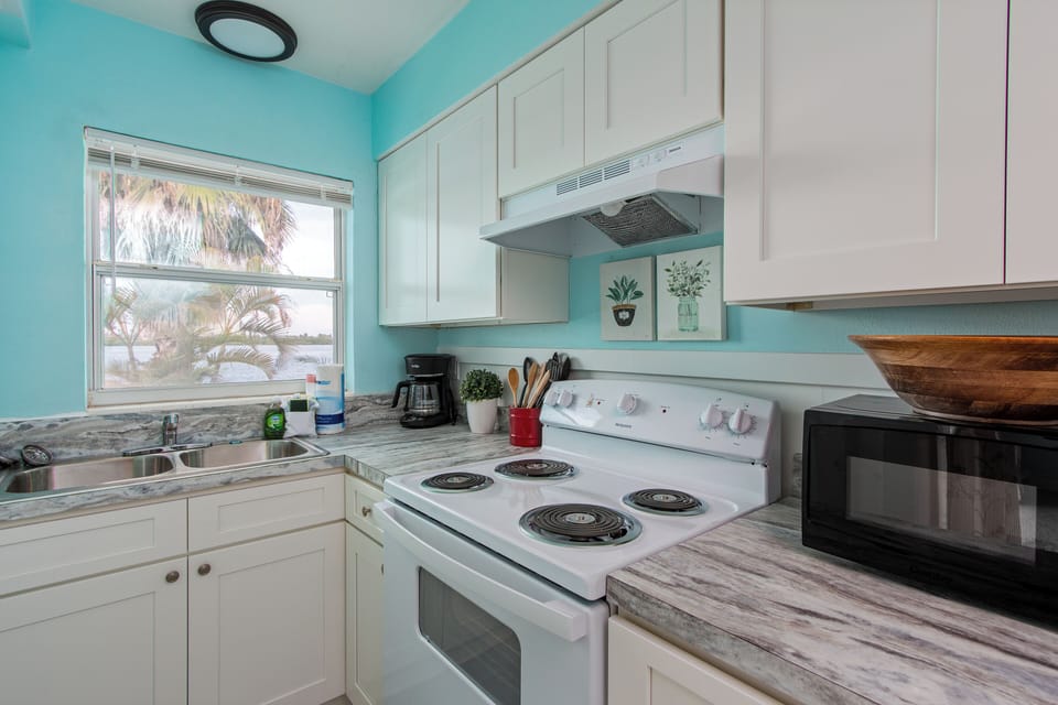 Fully equipped kitchen with modern appliances and basic cooking utensils