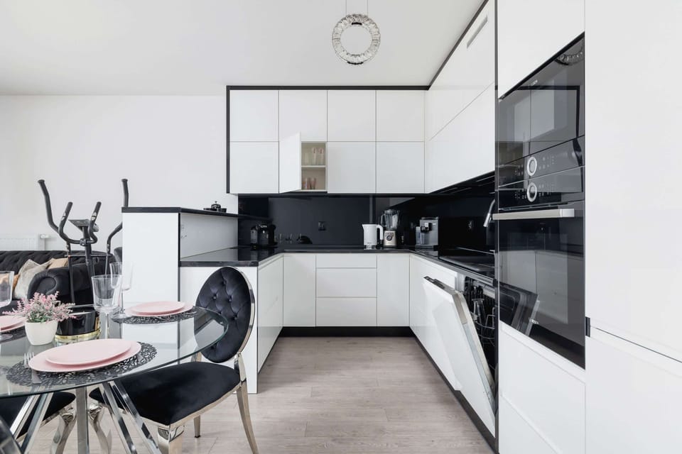 A stylish kitchen with modern appliances, a functional layout, and a monochromatic color scheme.

