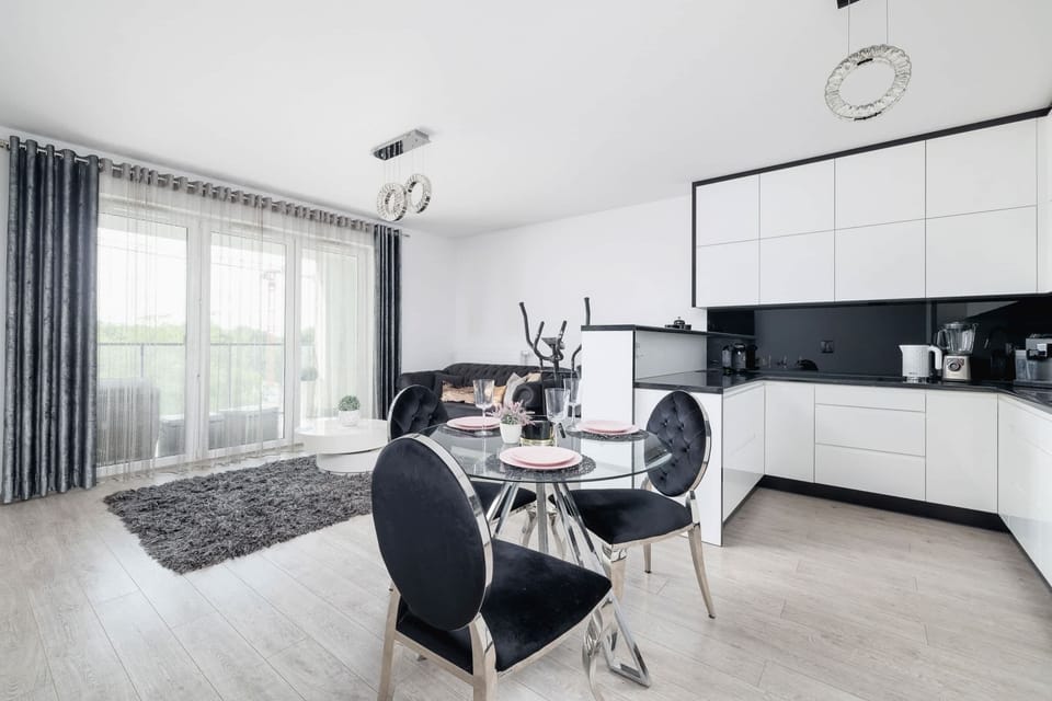 Another view of the open-plan living and kitchen area, featuring chic furniture and a cozy yet modern vibe.







