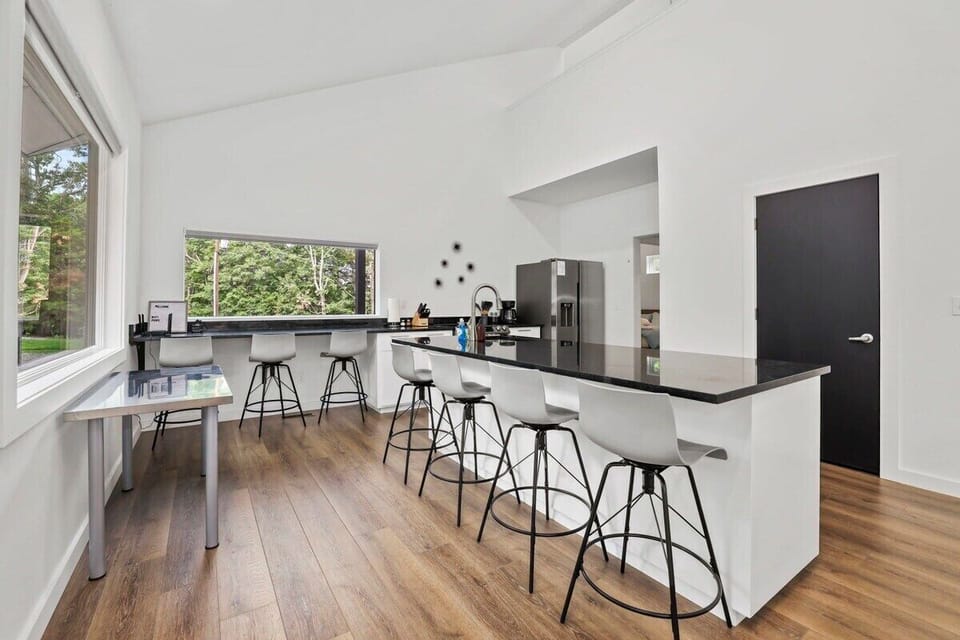 From here, we’ll take a walkthrough of our home! Upon arrival, you’ll find our main floor features a kitchen with new appliances and seating for 7.