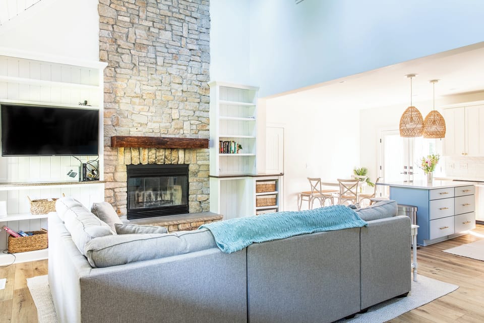 Snuggle up on the large sectional by the fireplace—perfect for those cozy nights in.