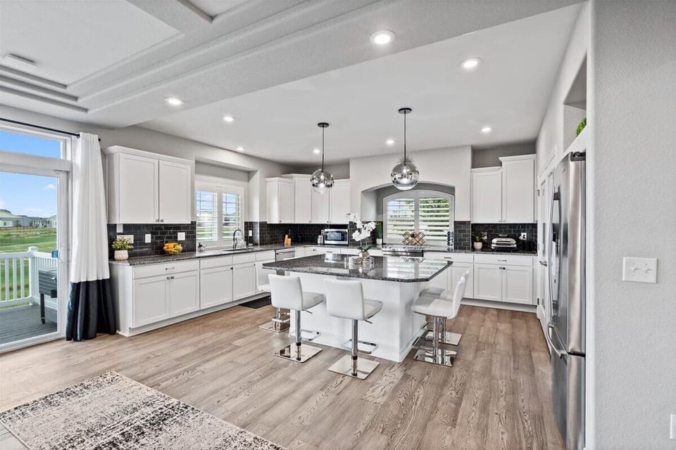 Fully Stocked Kitchen with Breakfast Bar Seating at the Kitchen Island