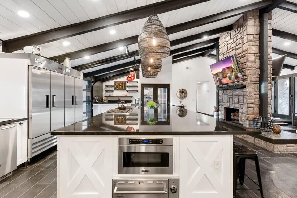 Gather around the oversized island in this luxe kitchen—perfect for hosting, grazing boards, and group meals.