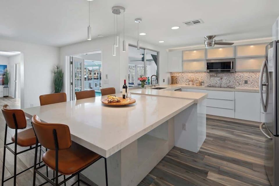 The centerpiece of the kitchen is a large island that offers ample space for preparing meals and gathering with friends and family.