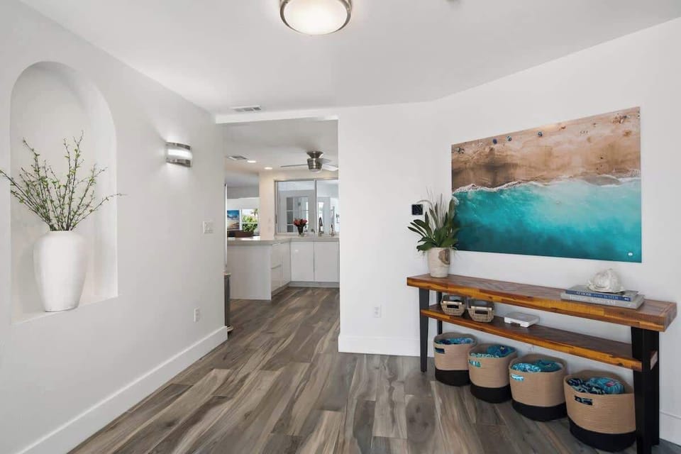 The welcoming entryway leads to the main living area of the home, which features an open floor plan with a comfortable living room, dining area, and modern kitchen