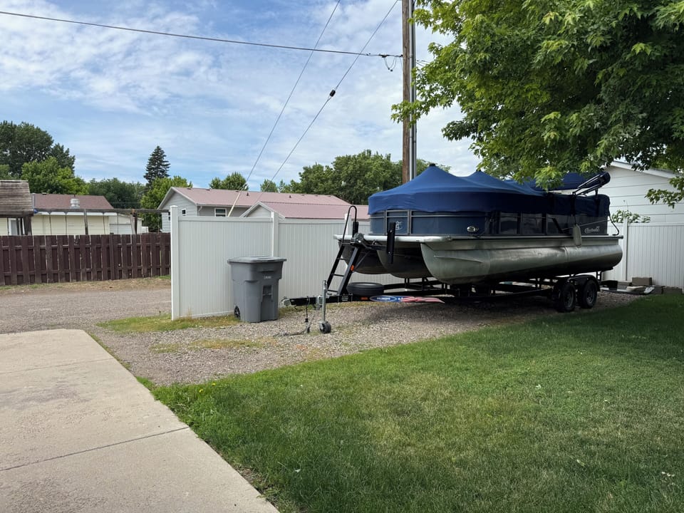 Boat parking and plug in our backyard parallel to the alley