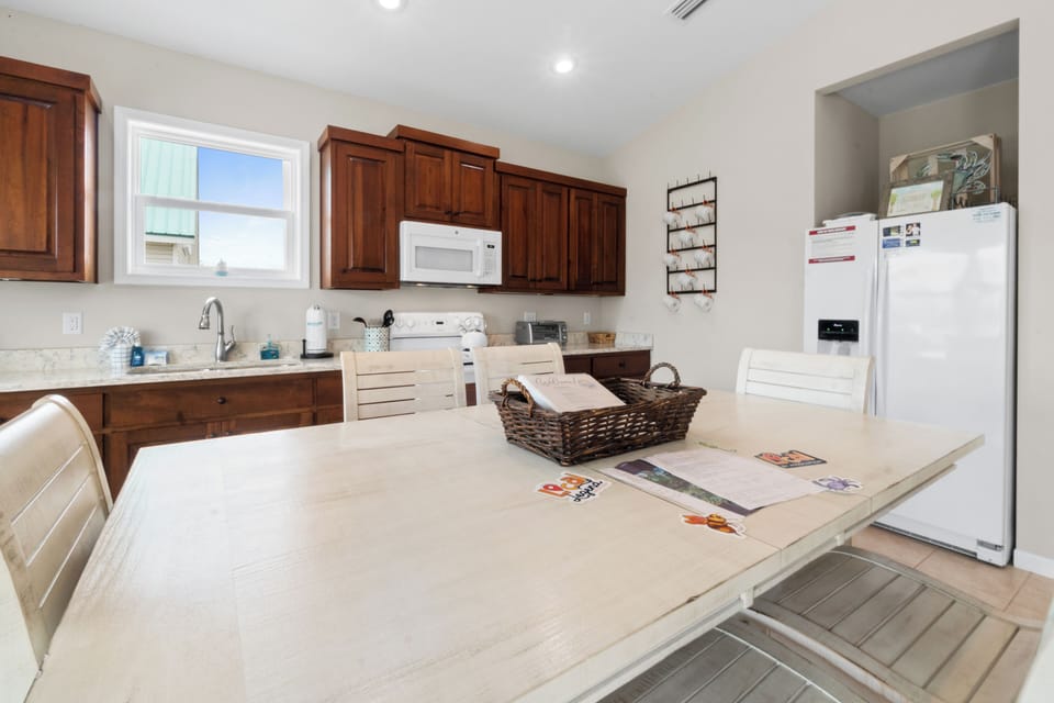 Your fully equipped kitchen invites culinary adventures with warm wood cabinets, modern appliances, and spacious counters perfect for family meals.