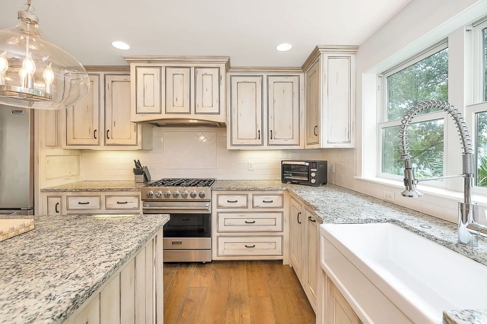 Chef's kitchen with a farmhouse sink and a gas range