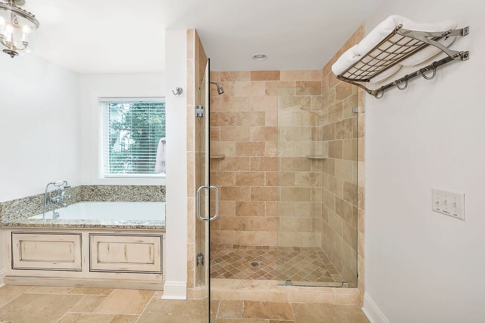 Primary Bathroom with a large walk-in shower and a large soaking tub