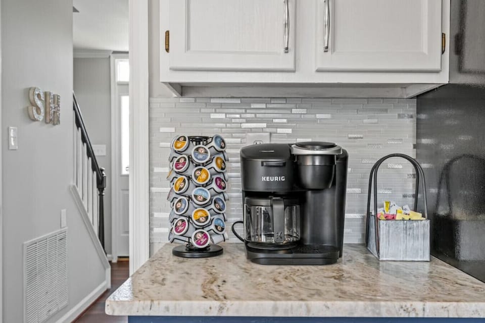 A full‑sized, fully equipped kitchen designed for cooking and connection. Enjoy modern appliances, a Keurig Duo, dishwasher, fridge with ice maker, bar seating, and plenty of counter space.
