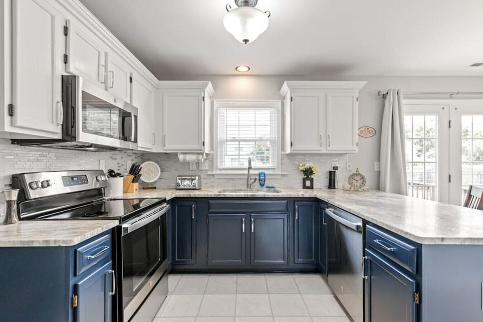 A full‑sized, fully equipped kitchen designed for cooking and connection. Enjoy modern appliances, a Keurig Duo, dishwasher, fridge with ice maker, bar seating, and plenty of counter space.