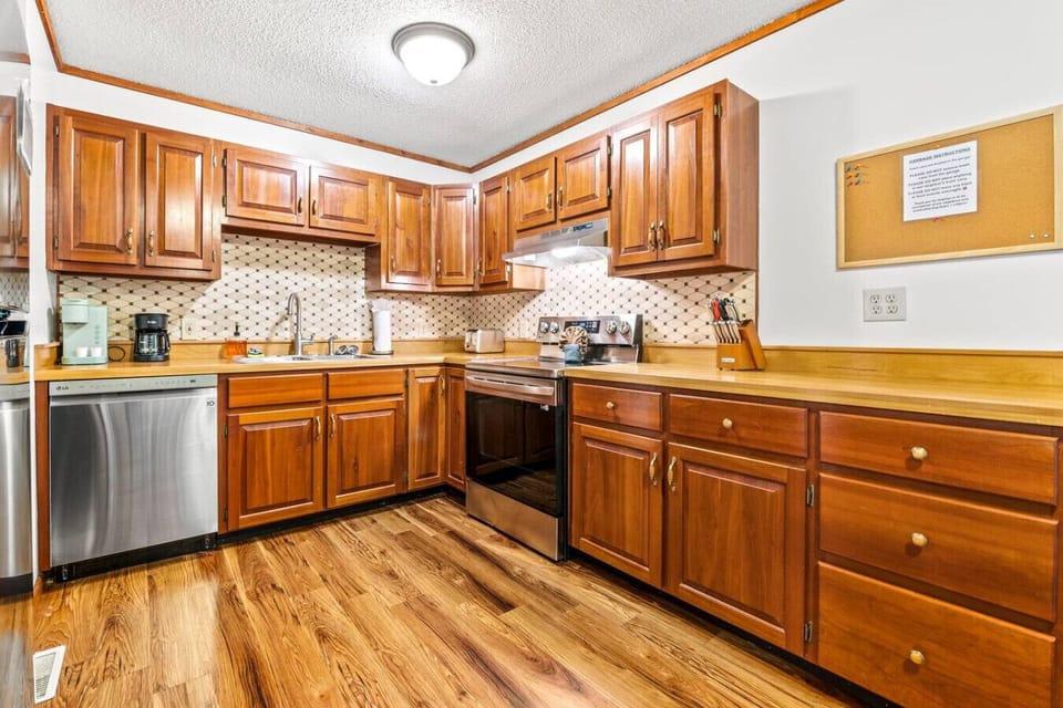Fully equipped kitchen with stainless steel appliances.