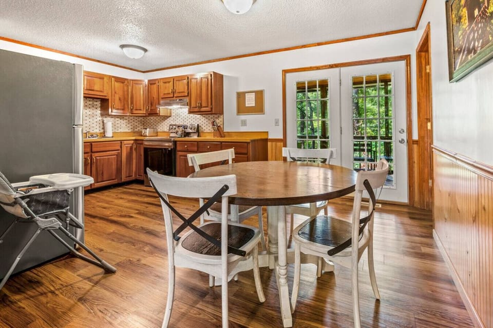 The kitchen offers direct access to the screened-in back porch area.