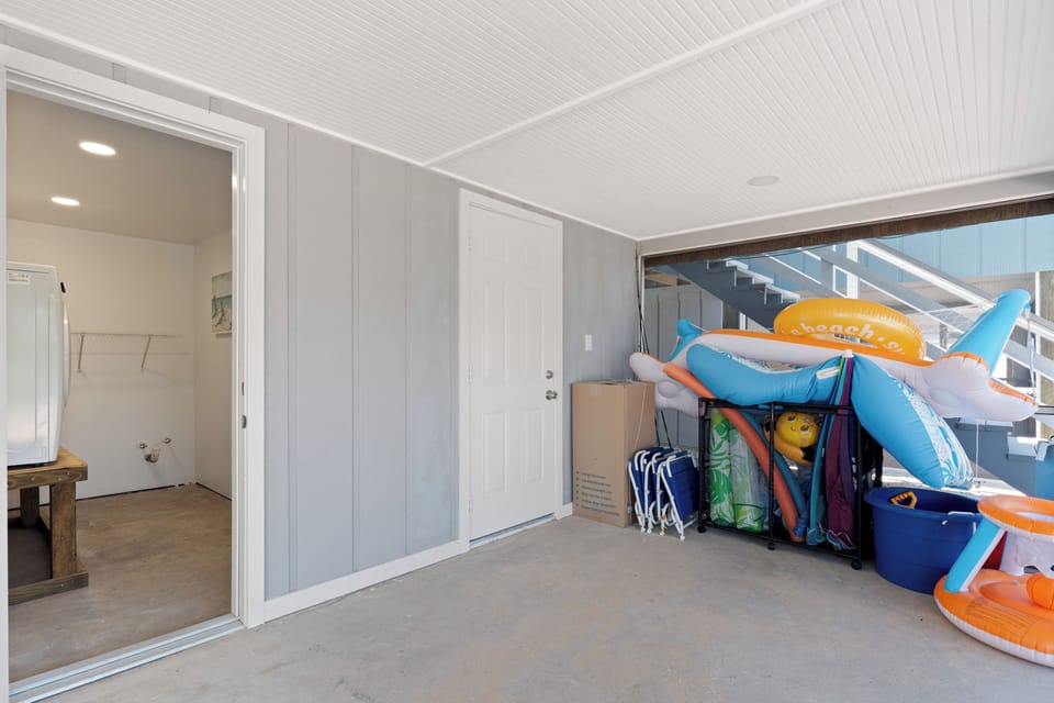 Shared washer and dryer located under unit one.