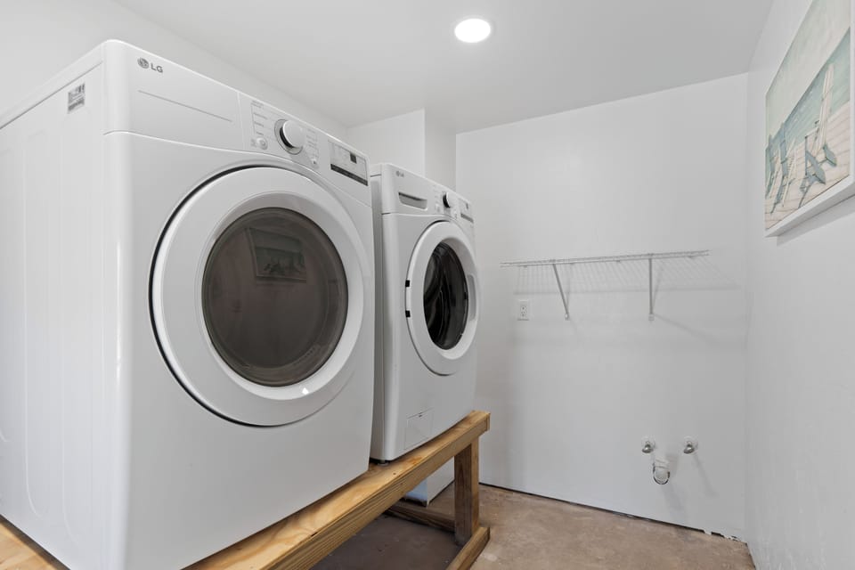 Shared washer and dryer located under unit one.