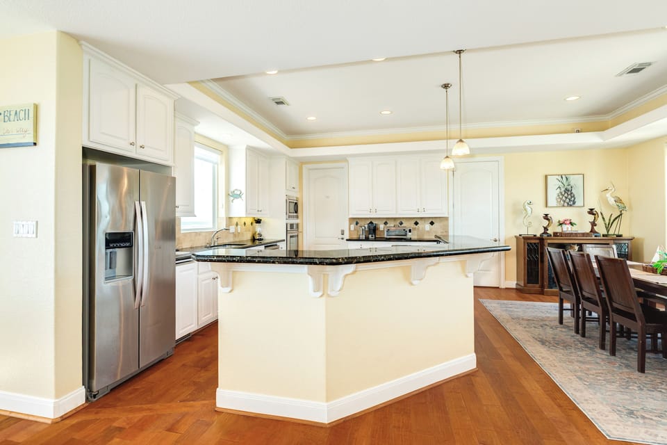 Large breakfast bar is great for serving meals to the dining area