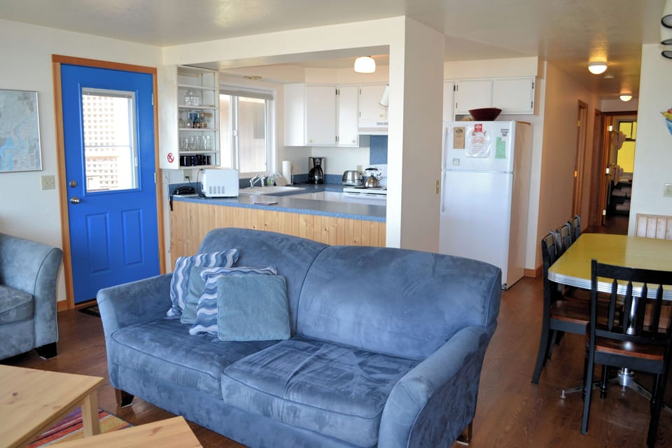 Living room with gas fireplace and ocean views. Kitchen and Dining area