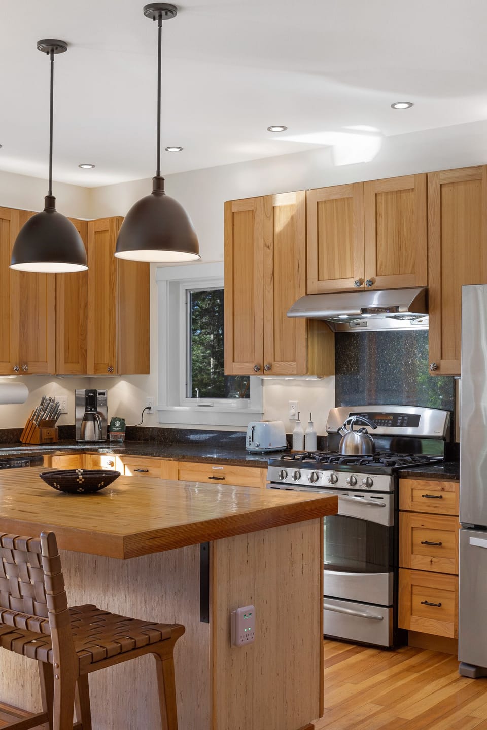 Ample kitchen lighting and USB charging ports available at the kitchen island,.