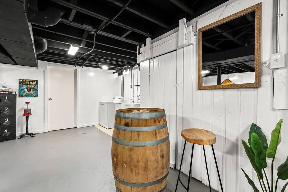  The wooden barrel provides a unique and inviting focal point, and the stools are perfect for sitting and chatting with friends. 