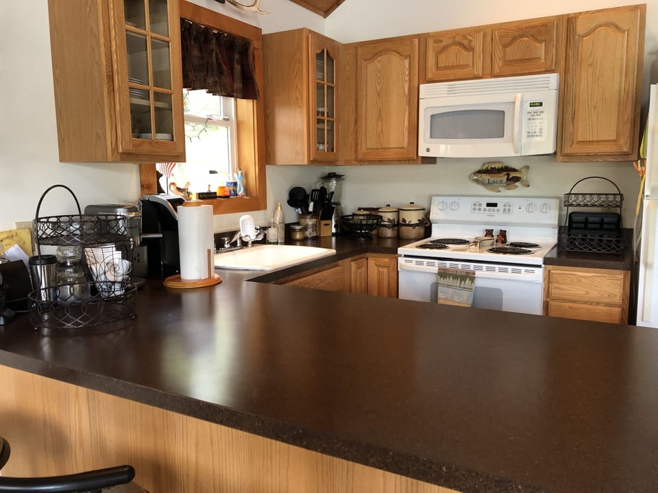 Full kitchen. Fully equipped with dishes, flatware, serving & food prep items.