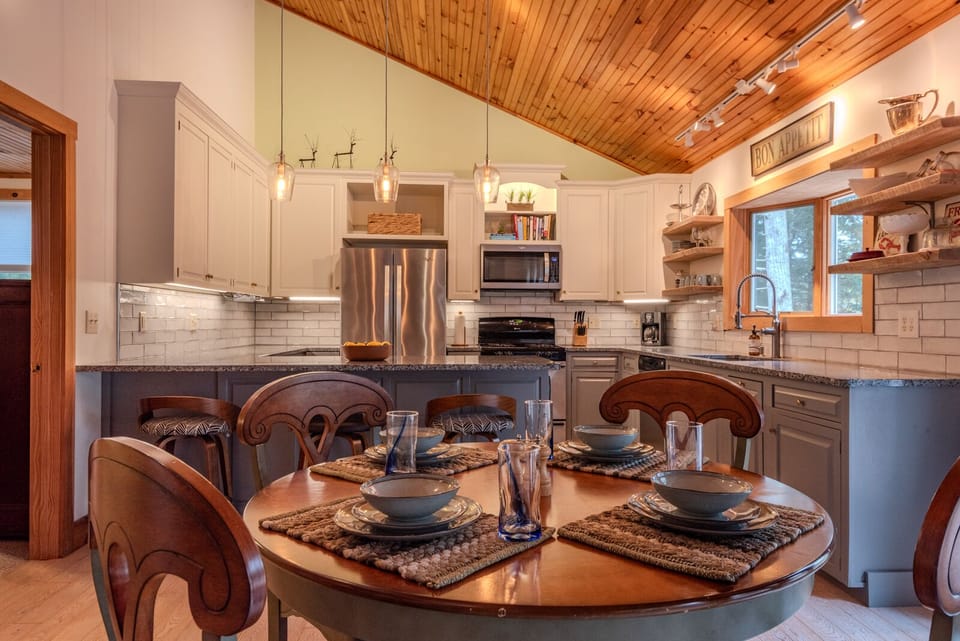 Prepare meals in upstairs fully stocked kitchen with counter and table seating.