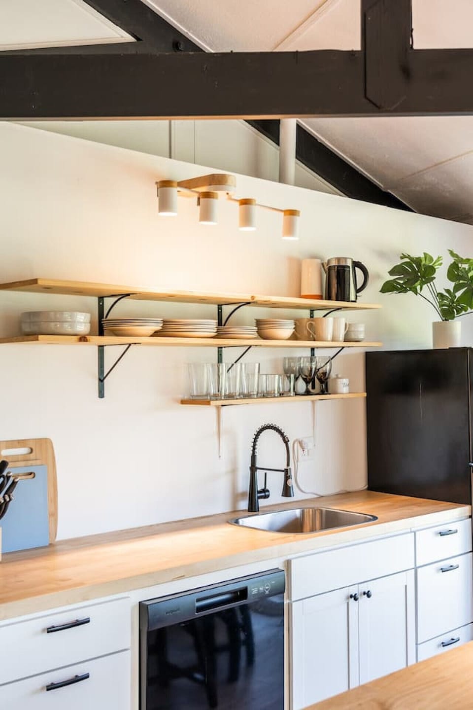 Modern kitchen with open shelving, sleek counters, and all the essentials for cooking at home.