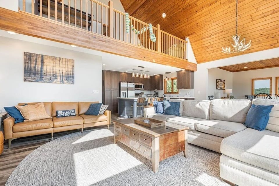 Main level living area with view of loft