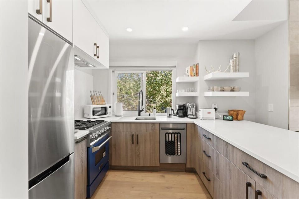 Chef's kitchen features stainless steel appliances: Zline gas stove, GE Profile