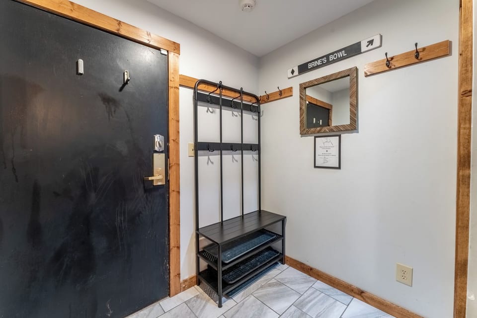 Your personal mudroom awaits with dedicated coat hooks, shoe storage, and rustic charm for seamless arrivals and departures.