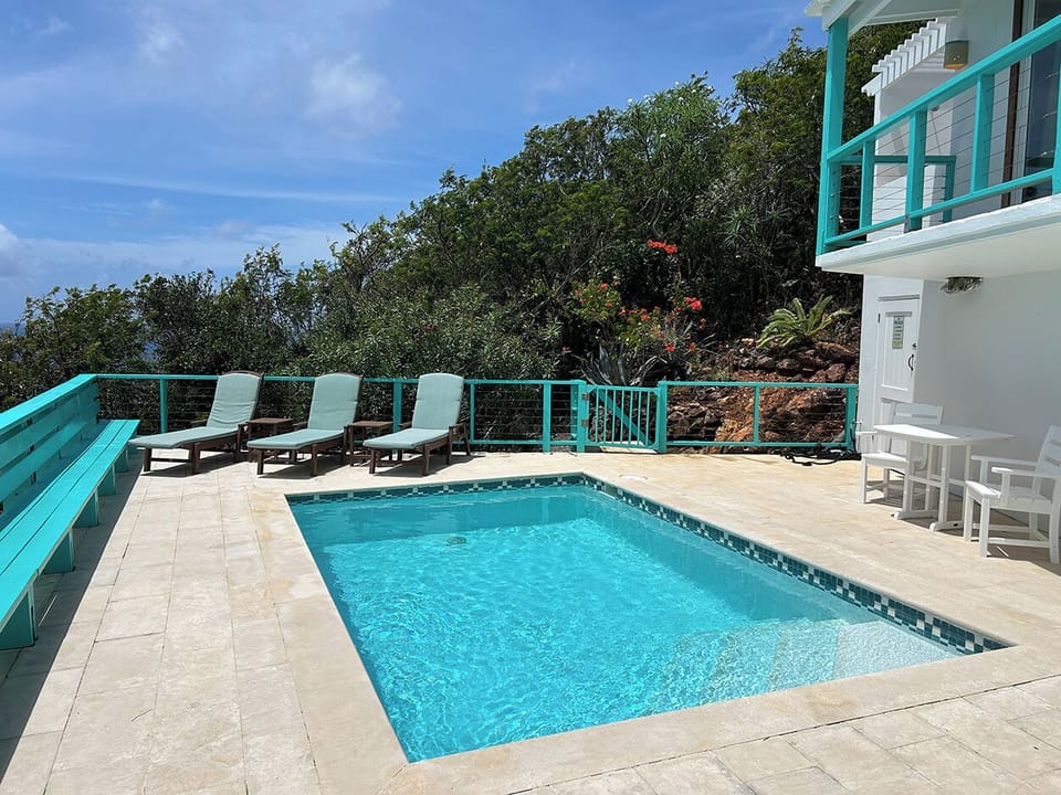 The master bedroom on the right looks out over the pool and sun deck