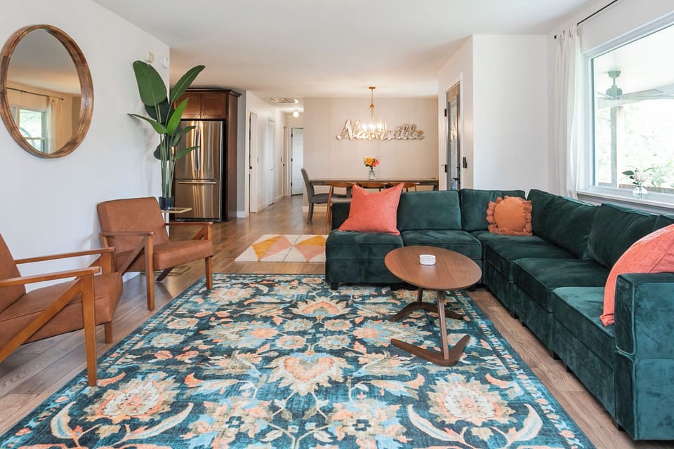 Living room open to the house, 65" TV, wood burning stove, seat big groups