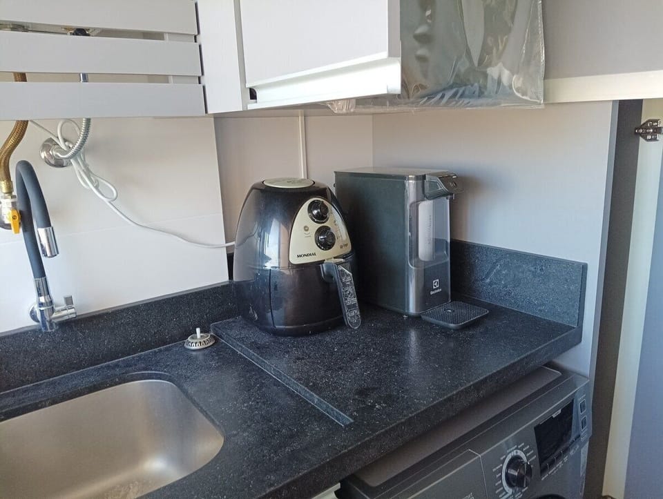 Deluxe Apartment, Pool Access | Private kitchen | Fridge, microwave, cookware/dishes/utensils, dining tables