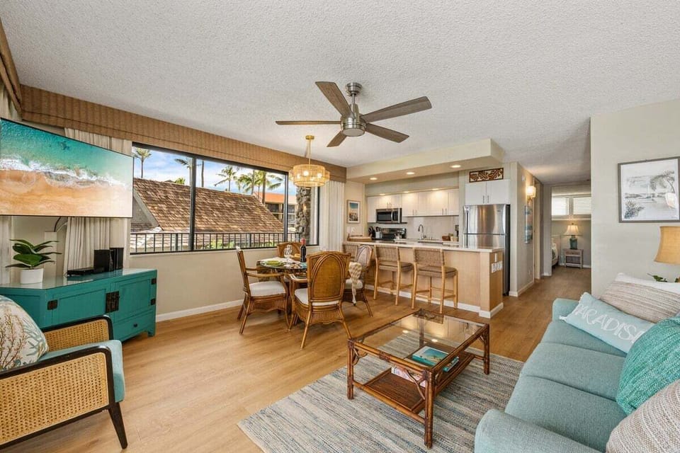 Open‑Concept Tropical Retreat.
A spacious, airy layout blending wicker textures, turquoise tones, and floor‑to‑ceiling windows that frame the coastline.