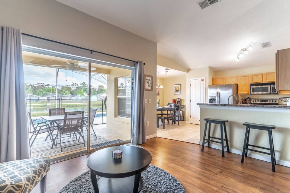 Open Concept kitchen, living and dining room with access to the private patio and pool