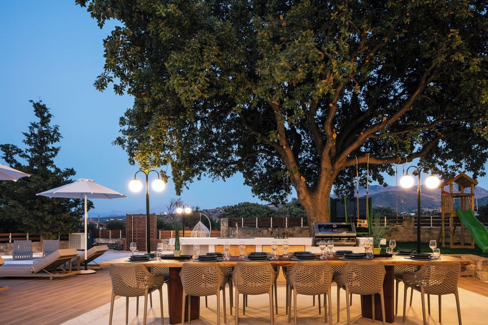 Gather around the long, wooden outdoor table accommodating up to 14 guests, creating an inviting atmosphere for shared meals and cherished moments.