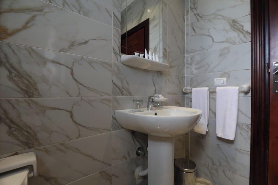 Shower, rainfall showerhead, towels, soap