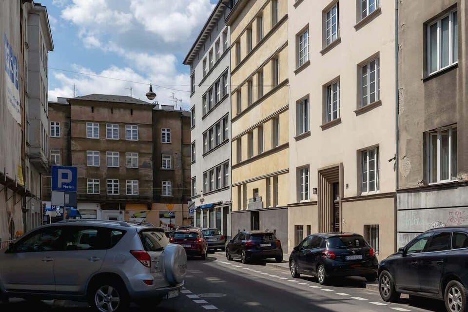 A street view of the building's exterior, providing an urban context with its classic architecture and surrounding residential area.