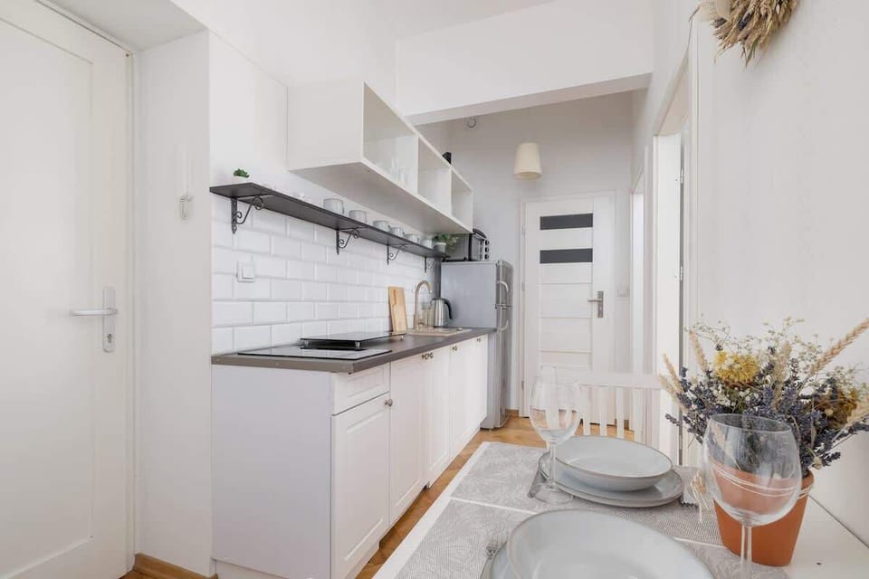 A sleek and modern kitchen with white cabinetry and a minimalist design.