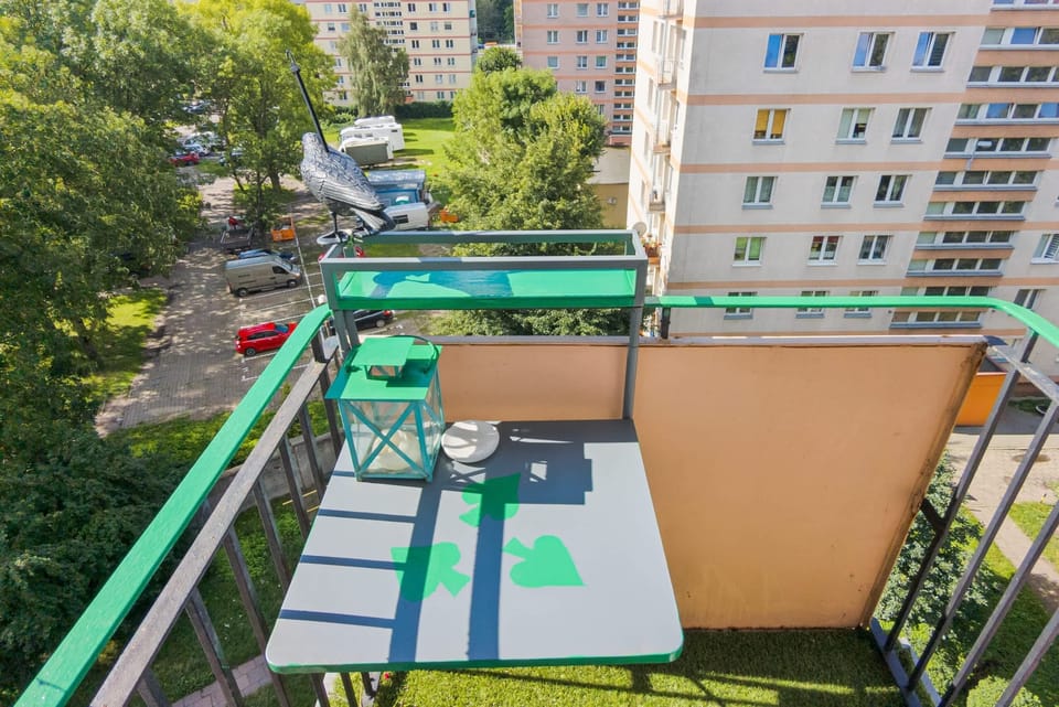 A balcony overlooking the courtyard, complete with a small table and chairs, ideal for enjoying fresh air and the view.







