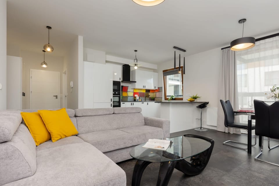 A wide-angle view of the open-plan living and dining area, highlighting its airy layout and stylish decor.

