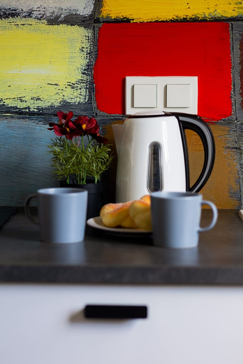 A close-up of a vibrant and colorful kitchen corner with essential appliances, adding personality and functionality.

