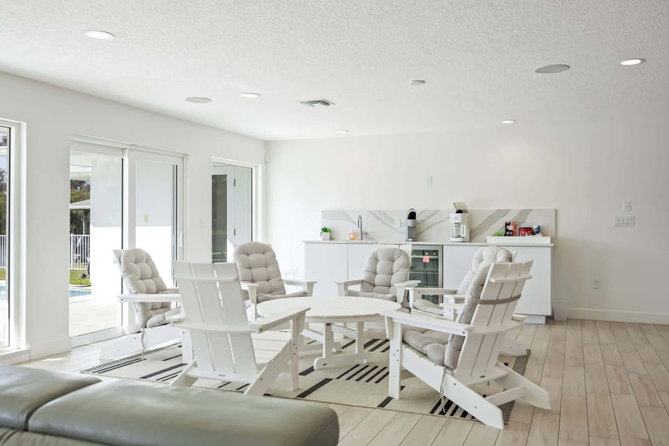 Bright seating area with cushioned chairs and a kitchenette in a modern open space