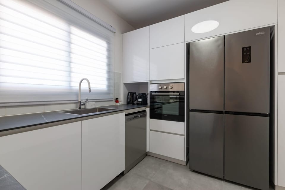 Premium stainless appliances supporting convenient extended stays in this modern home.