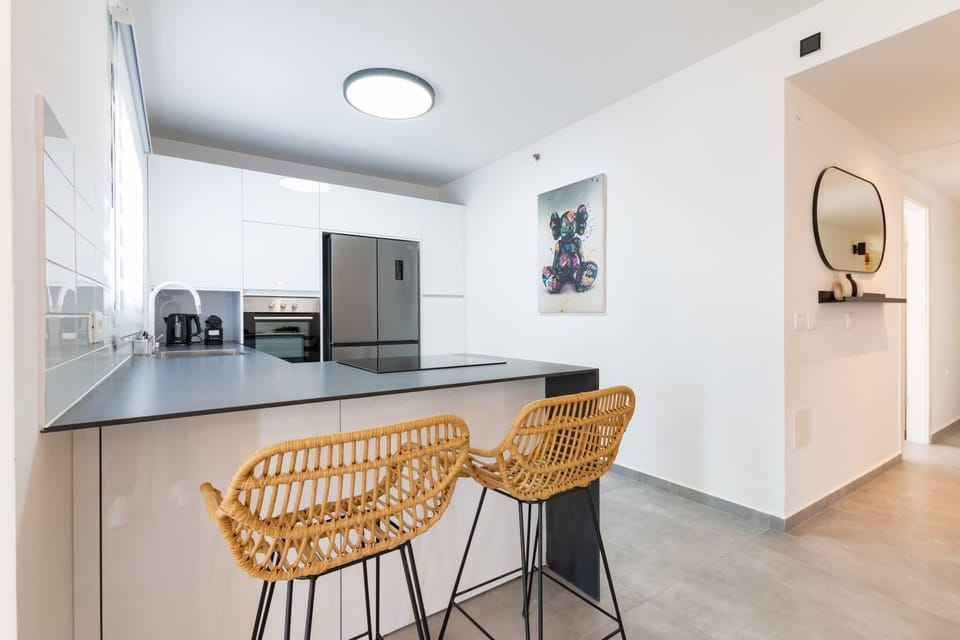 Breakfast bar seating ideal for quick mornings before exploring vibrant neighborhood.