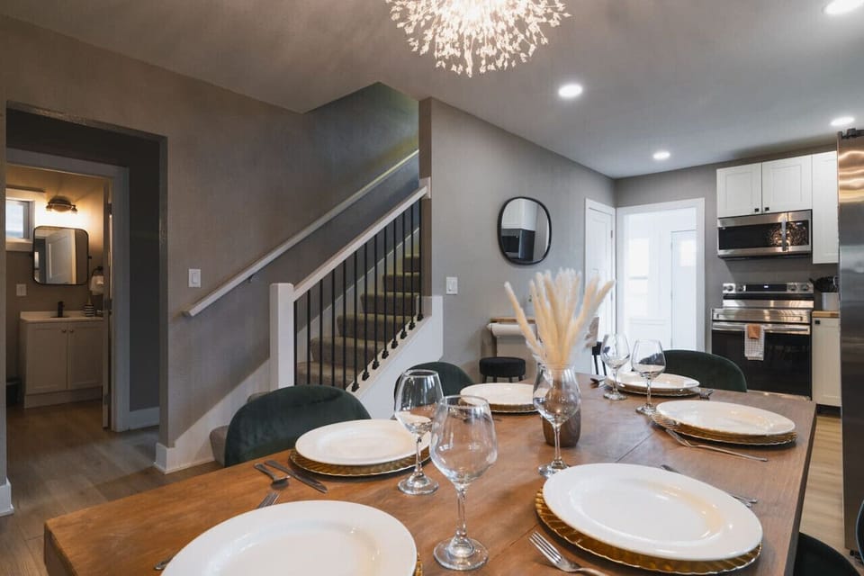 A sleek and modern kitchen flows into the dining area, with stylish details and an open feel.