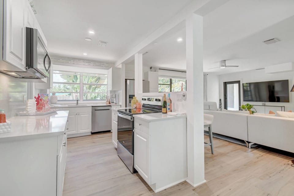 Seamless elegance: Our space combines a fully equipped, high-end kitchen with the stylish comfort of an adjoining living room, perfect for those who appreciate luxury and convenience in Delray Beach.