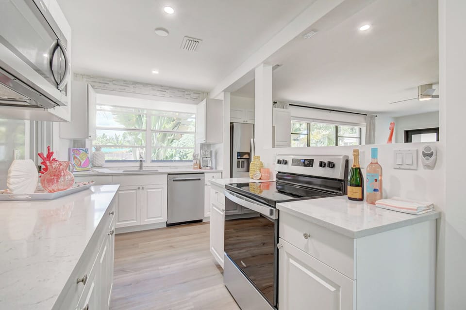 Clean white kitchen with full-size appliances, generous counter space, and everything needed for easy meals.