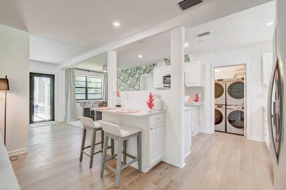 Sleek and inviting: With just two bar stools, our compact and stylish bar area becomes a perfect nook for morning coffees or evening chats, complemented by the convenience of our modern kitchen behind.