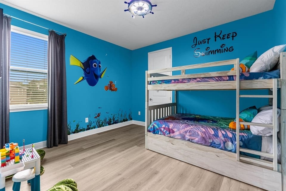 Delightful Finding Nemo-themed bedroom featuring spacious full-over-full bunk beds and twin trundles, perfect for families or friends, with whimsical decor that immerses guests in the oceanic world.